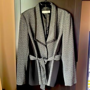 Gently worn Tahari blazer with detailed lapel collar and belt at waist.